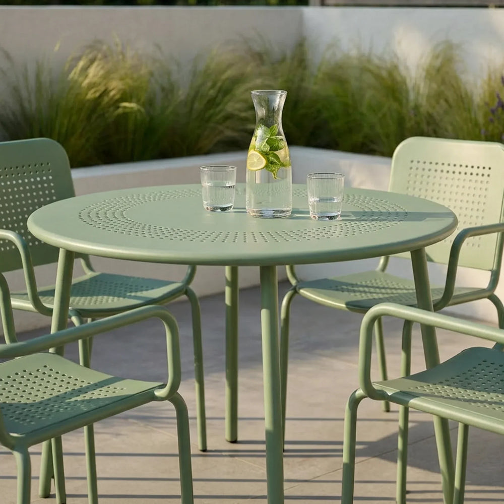 Olive green metal outdoor dining set with matching chairs on patio