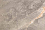 Marble dining table surface with light grey and brown veining, close-up detail