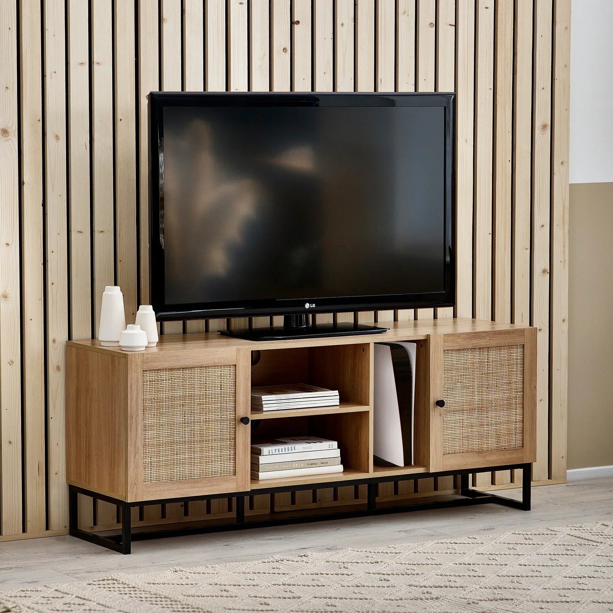 Oak TV unit with cane panel doors, open shelves, and black frame in modern living room