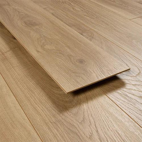 Pale oak laminate flooring plank with wood grain texture on floor surface