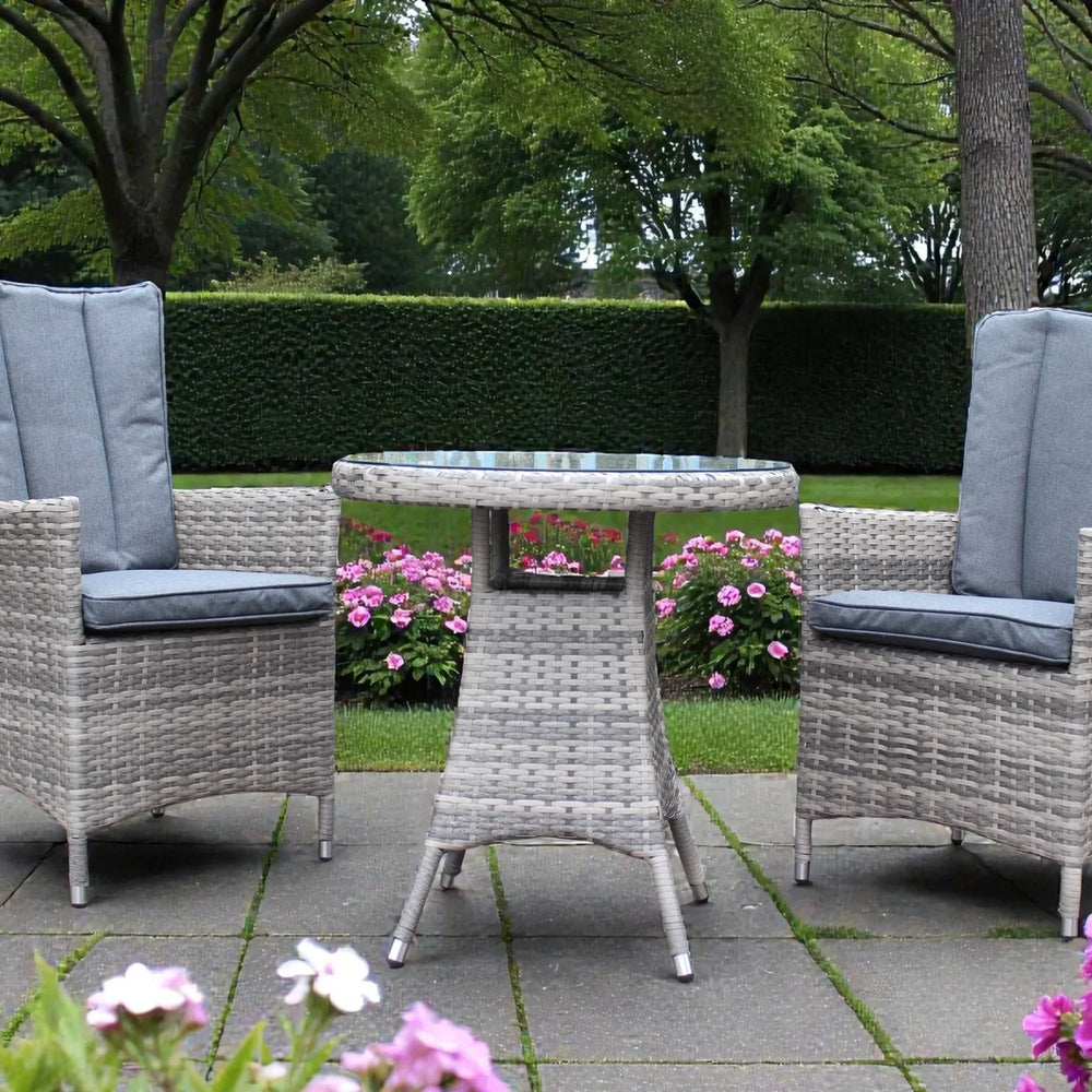 Grey rattan garden bistro set with two cushioned chairs and round table on patio