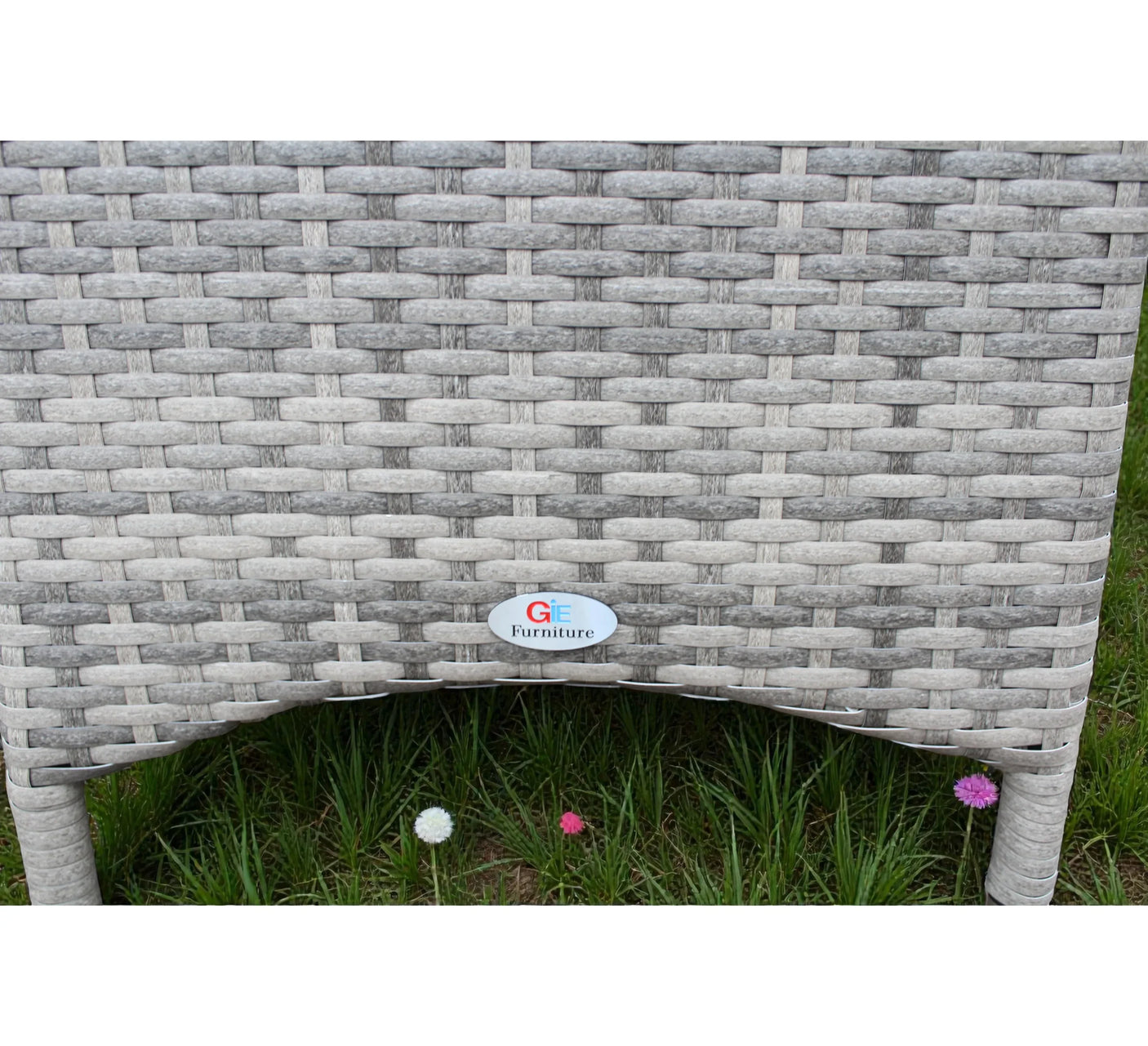 Close view of grey rattan garden bistro set table leg and weave texture outdoors