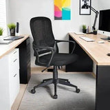 Black mesh office chair on castors in modern home workspace with wood desks