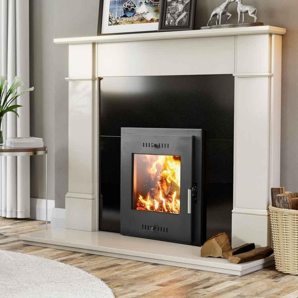 Black wood burning stove set in cream fireplace with basket of logs on wood floor