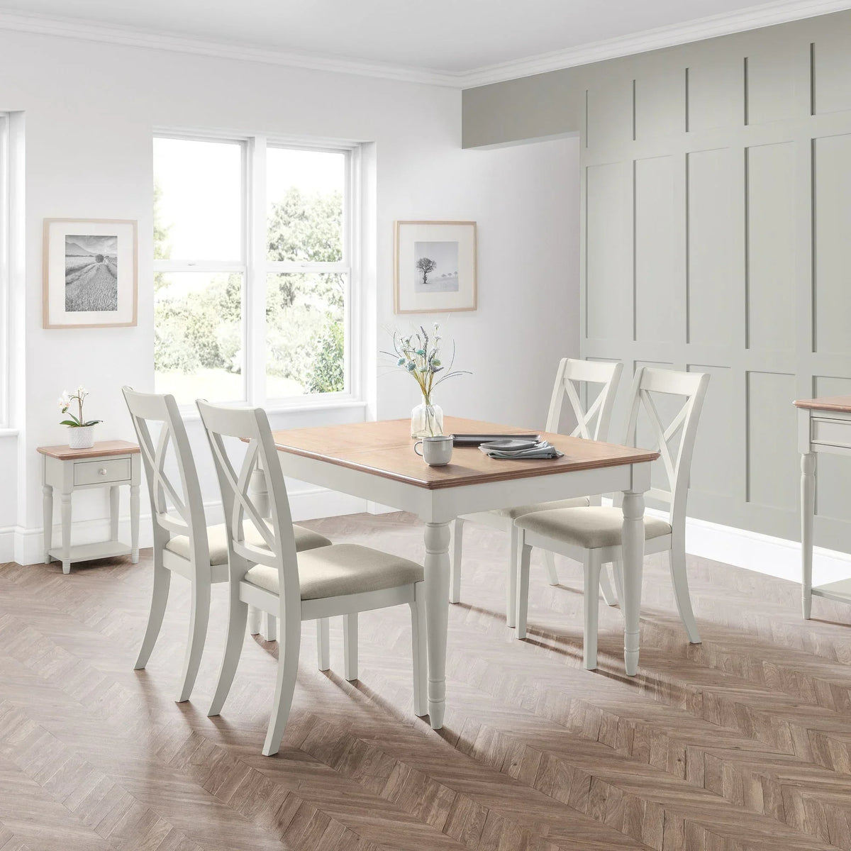 Provence dining set with four white chairs and wooden table in a bright dining room