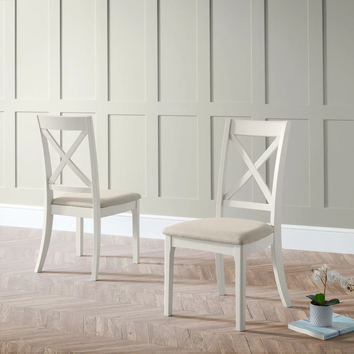 Provence dining chairs with cream upholstered seat and white wood frame in minimalist room