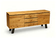 A mid-century modern wooden sideboard with three drawers in the center, flanked by two cabinet doors, finished in a warm natural wood tone with black legs and drawer pulls, shown on a white background.