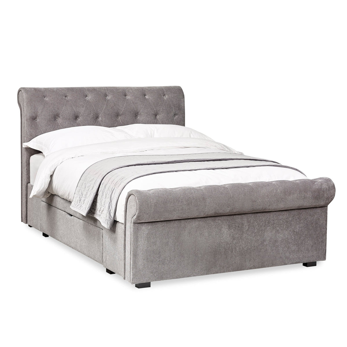 Grey fabric double bed angled from right, tufted headboard, footboard, white bedding, no drawers opened.