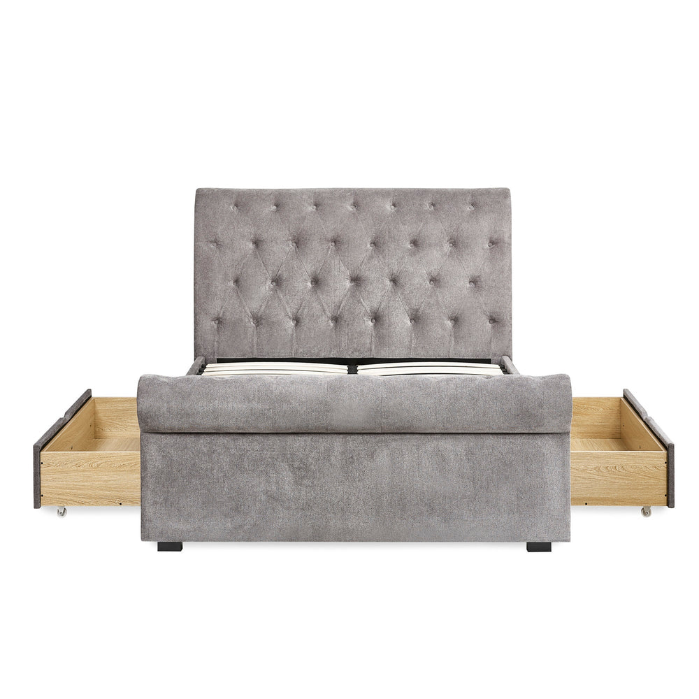 Frontal view of grey fabric double bed with fully opened side drawers revealing wooden storage inside.