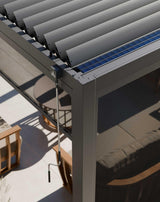 Aluminium pergola with adjustable louvre roof, manual handle, and mesh side screen