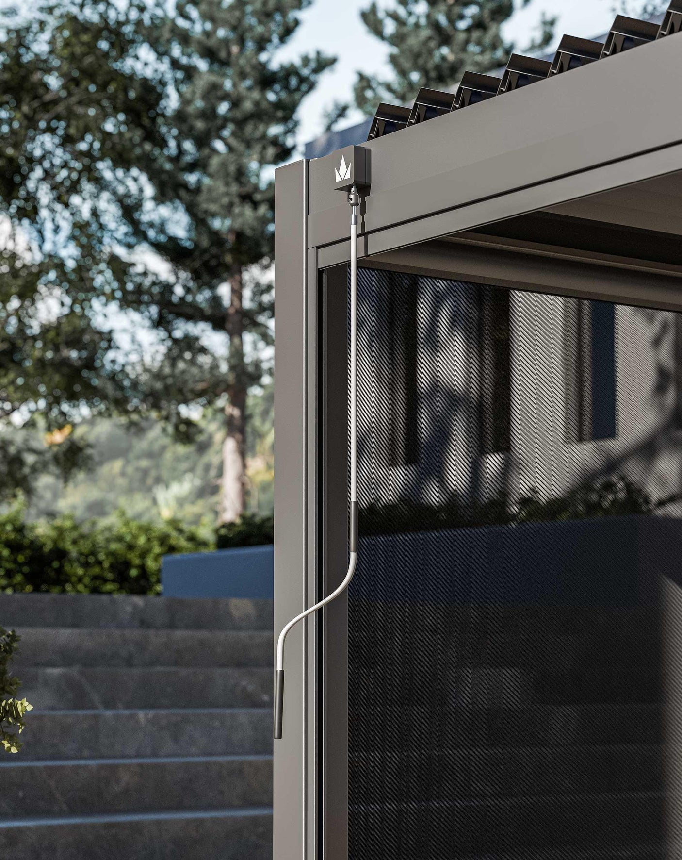 Grey metal pergola with winding handle and mesh side panel, modern garden background