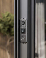 Close-up of smart patio door control panel with buttons for power, lighting, and microphone