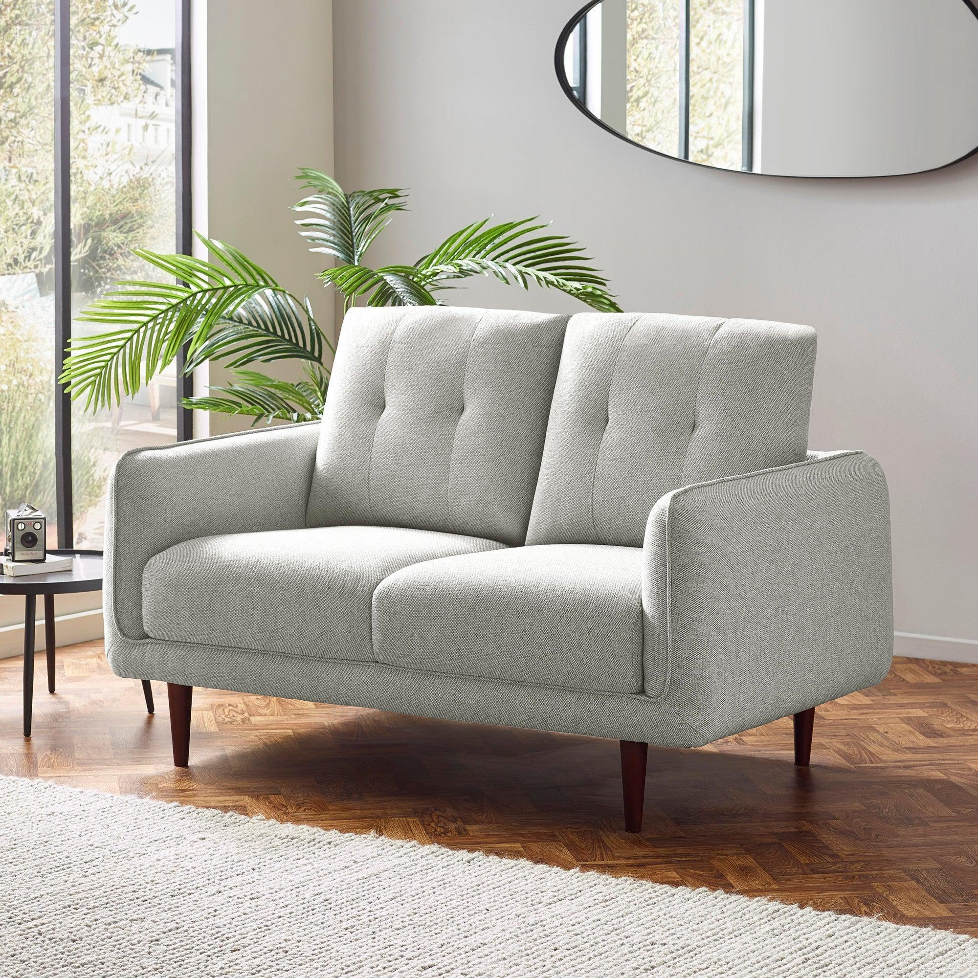Light grey fabric two seater sofa with wooden legs in modern living room setting