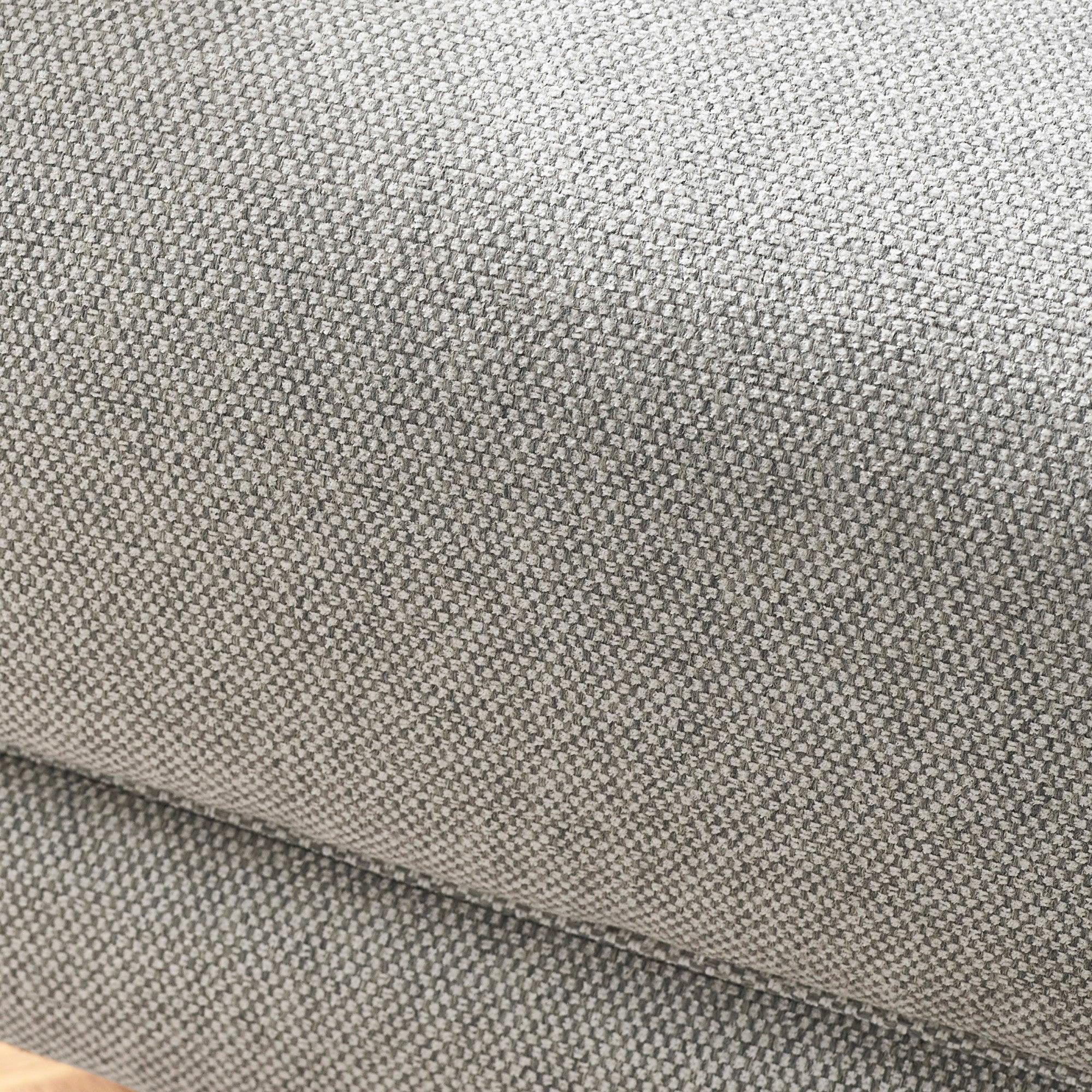 Close-up of grey woven fabric upholstery on sofa cushion