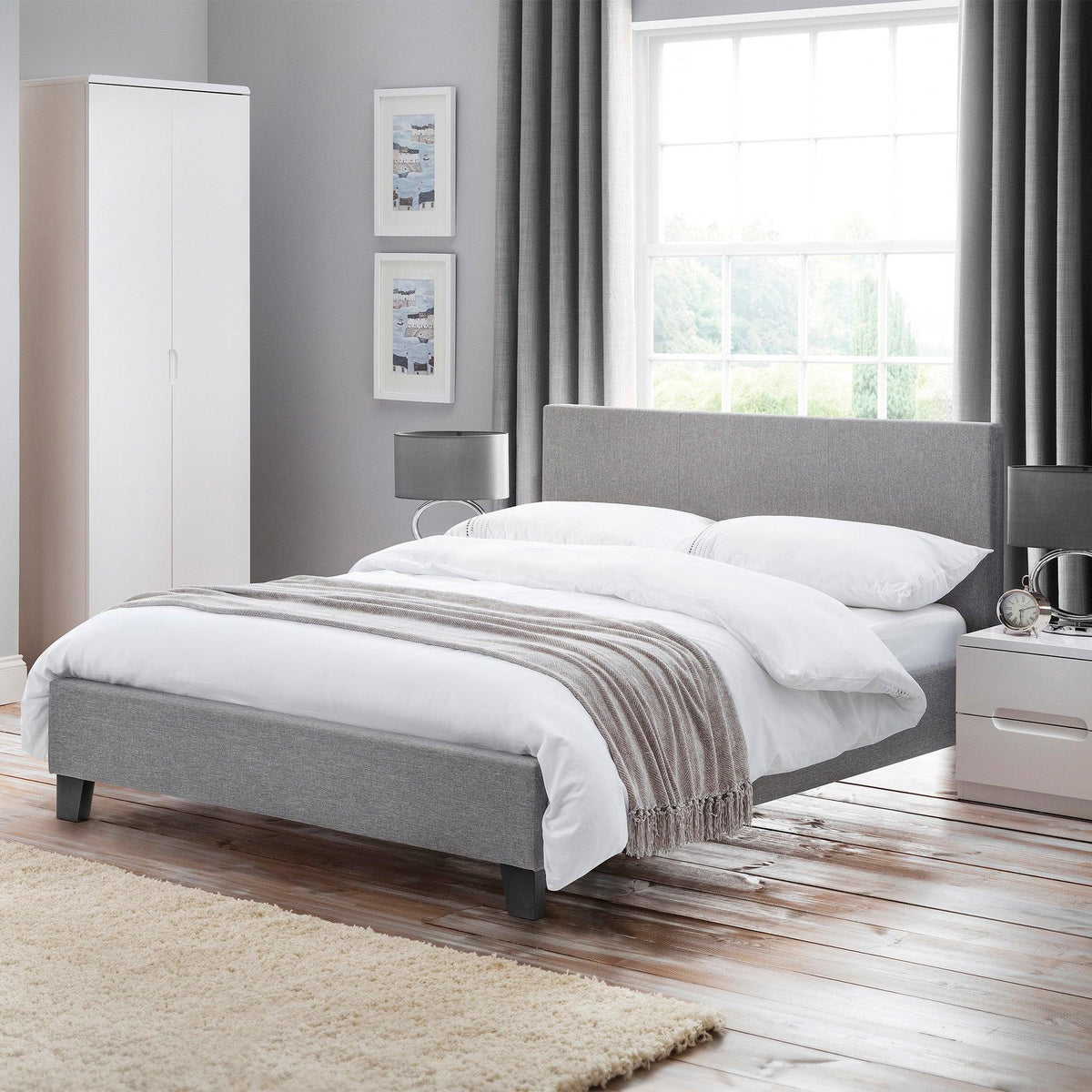 Light grey linen single bed with headboard in modern bedroom, styled with white bedding