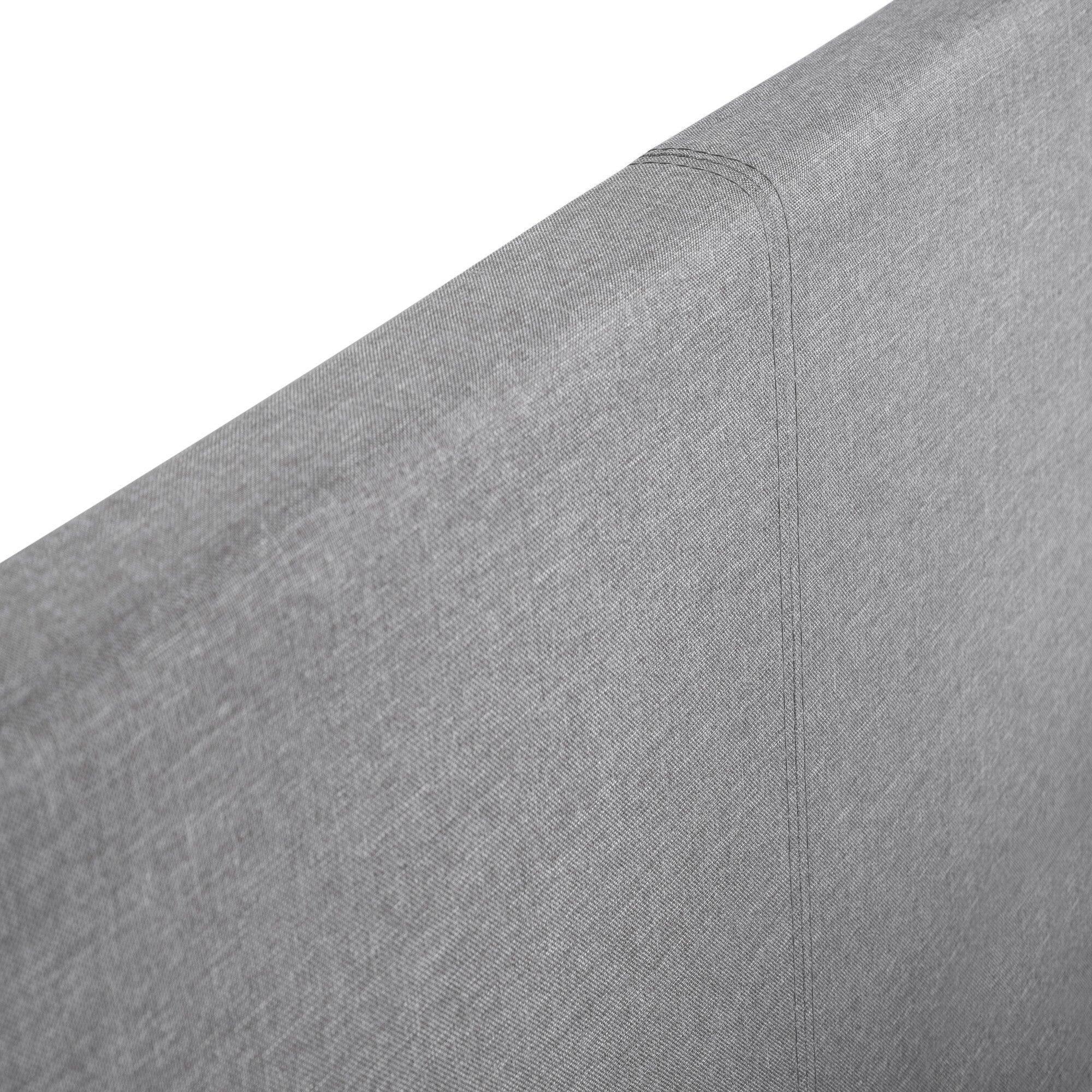 Close-up of grey fabric headboard on storage bed, showing stitching and texture detail