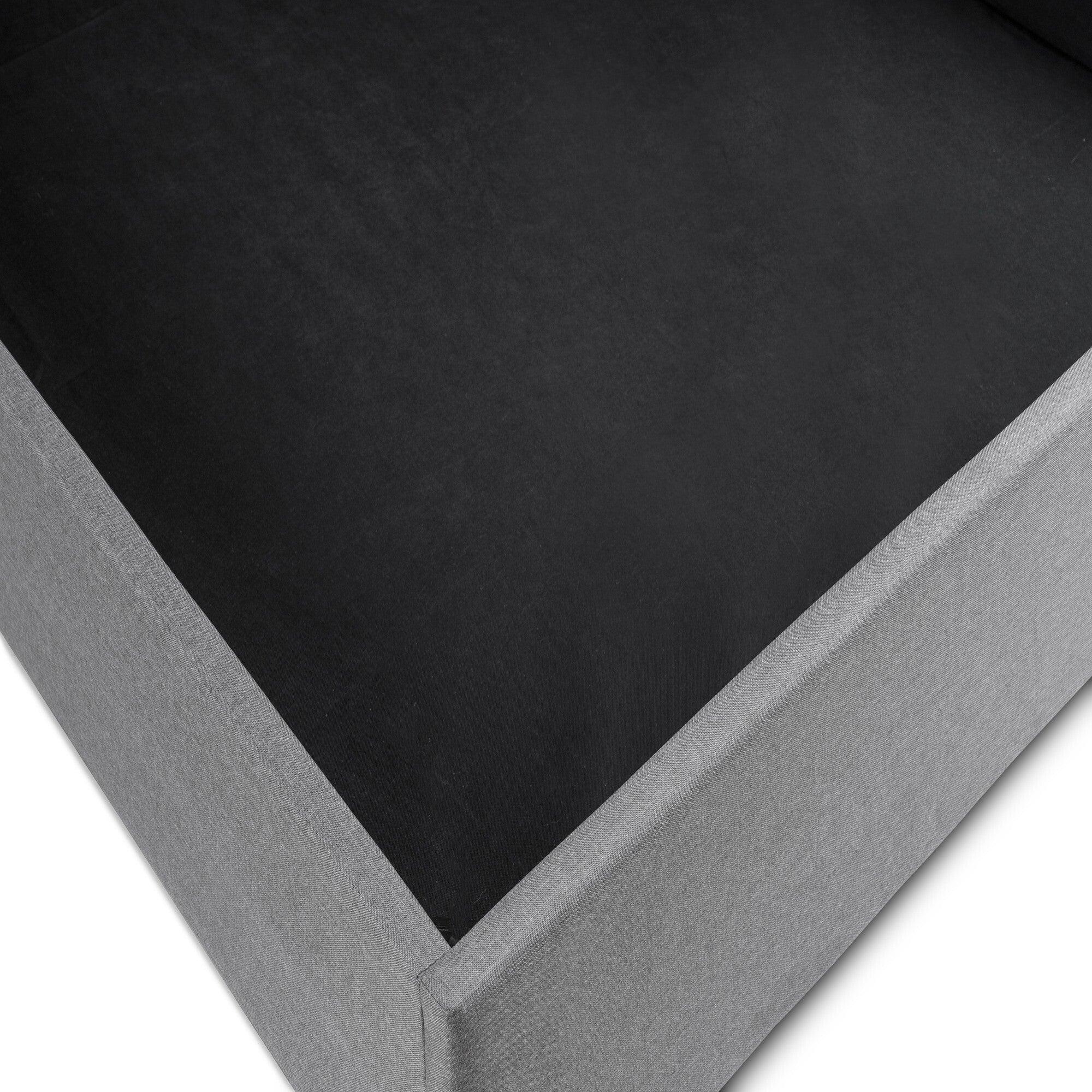 Close-up of lift-up storage bed base in grey fabric finish