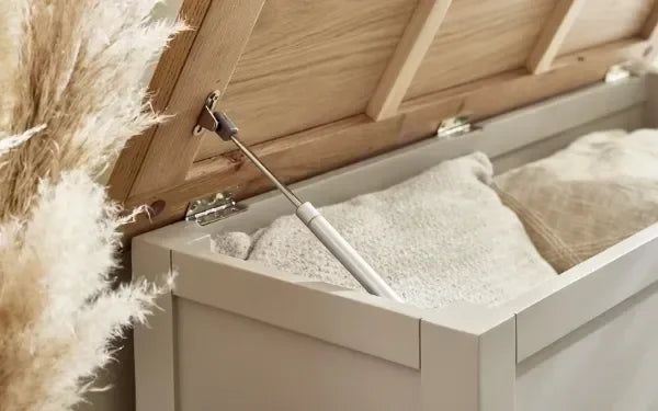 White wooden storage bench with open lid showing blankets inside