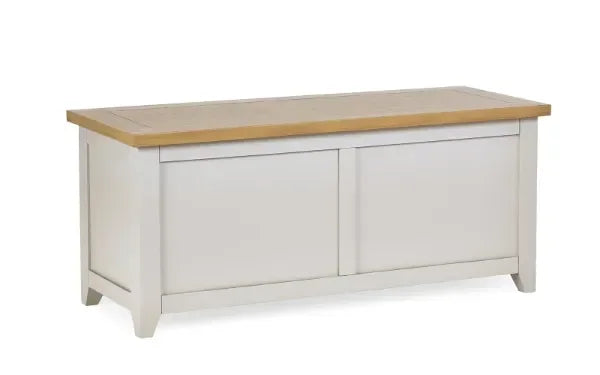 Wooden storage bench with white painted base and natural oak top, angled front view