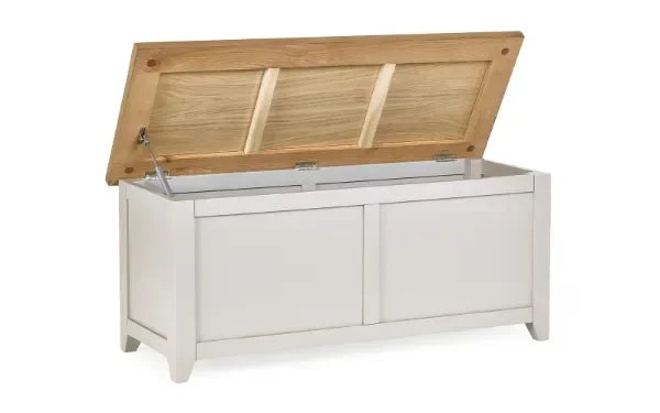 Wooden storage bench with white base and hinged natural oak lid, lid open