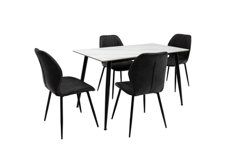Modern black velvet dining chairs with slim metal legs around white rectangular table