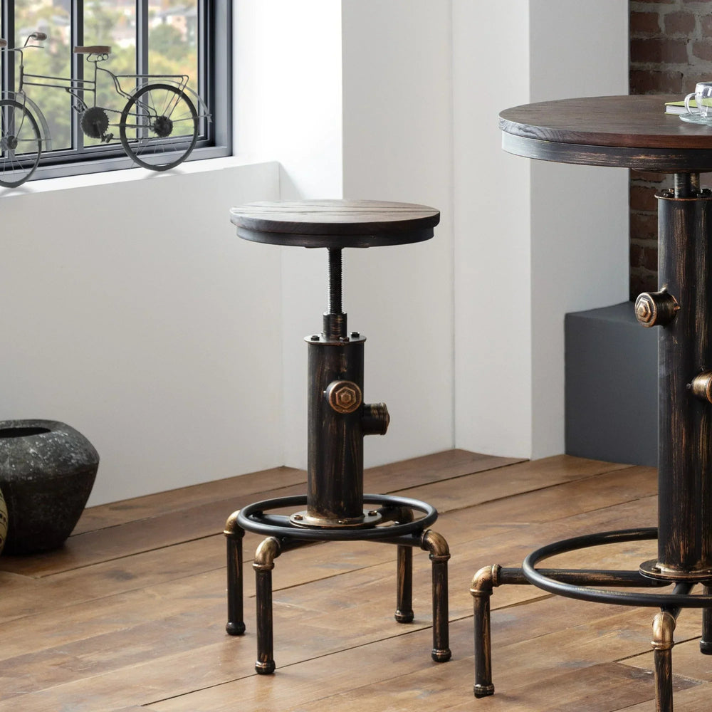 Industrial bar stool with dark wood seat and metal pipe base on wooden floor