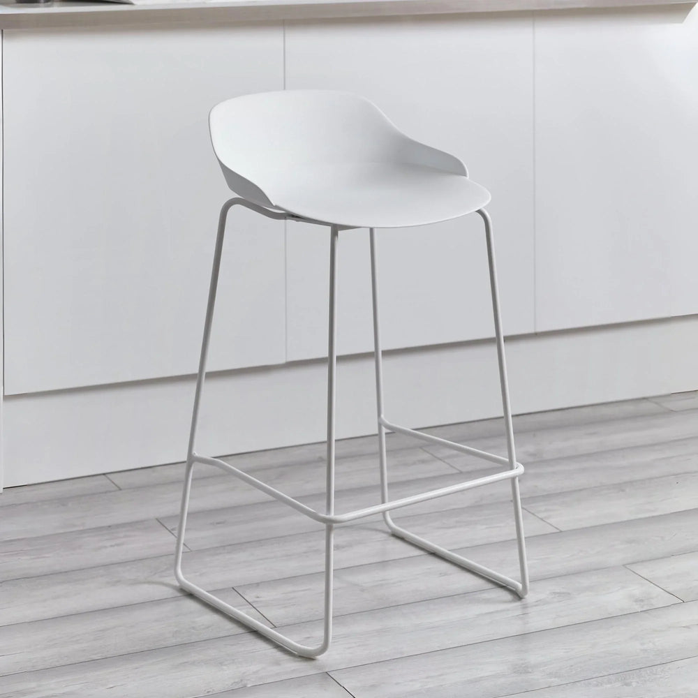 White bar stool with curved seat and metal legs in modern kitchen setting