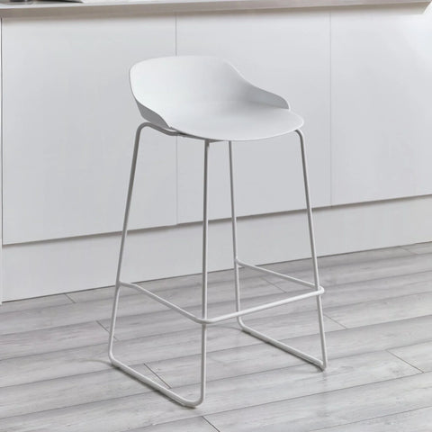 White bar stool with curved seat and metal legs in modern kitchen setting