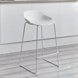 White bar stool with curved seat and metal legs in modern kitchen setting
