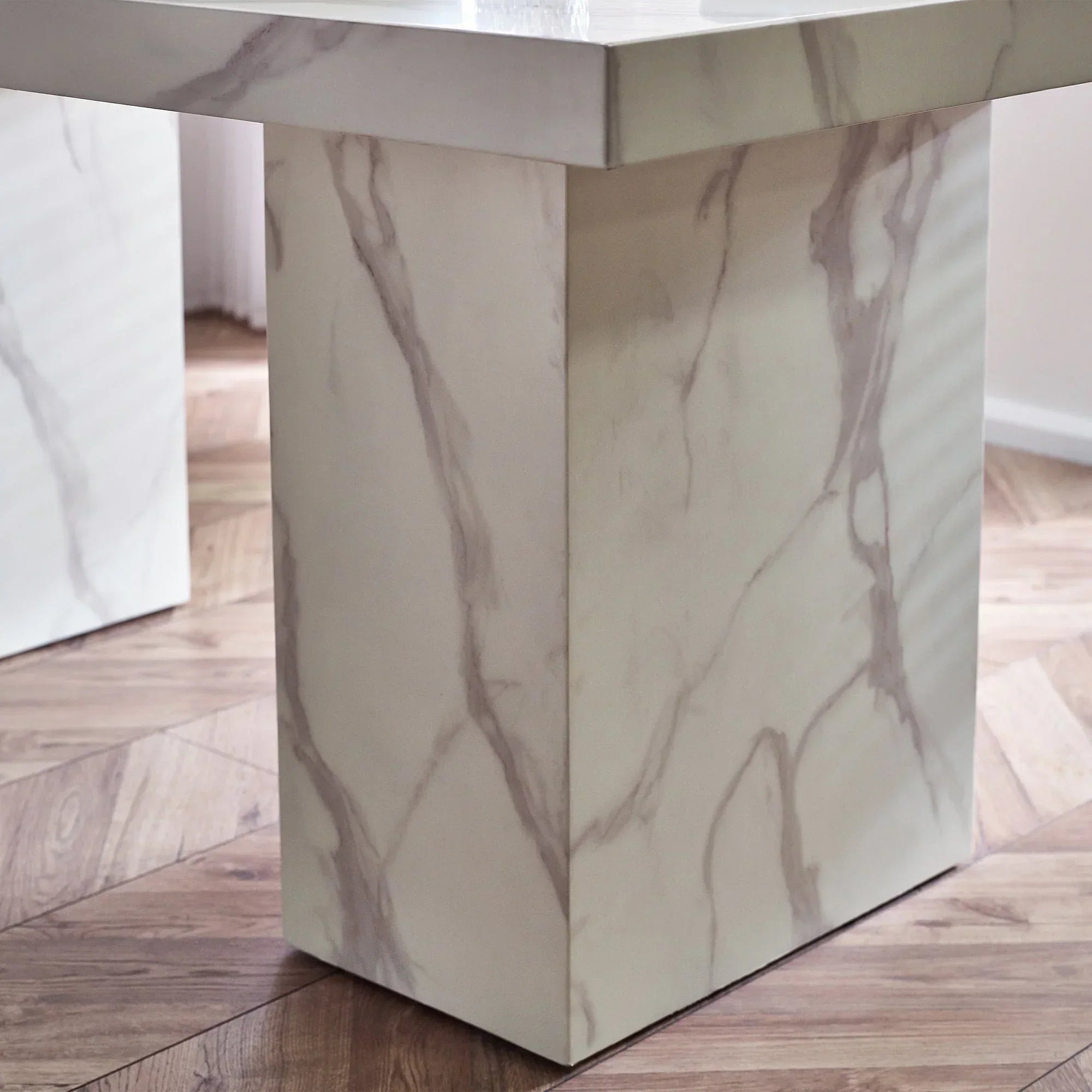 White marble effect dining table base on wooden floor, close-up angle