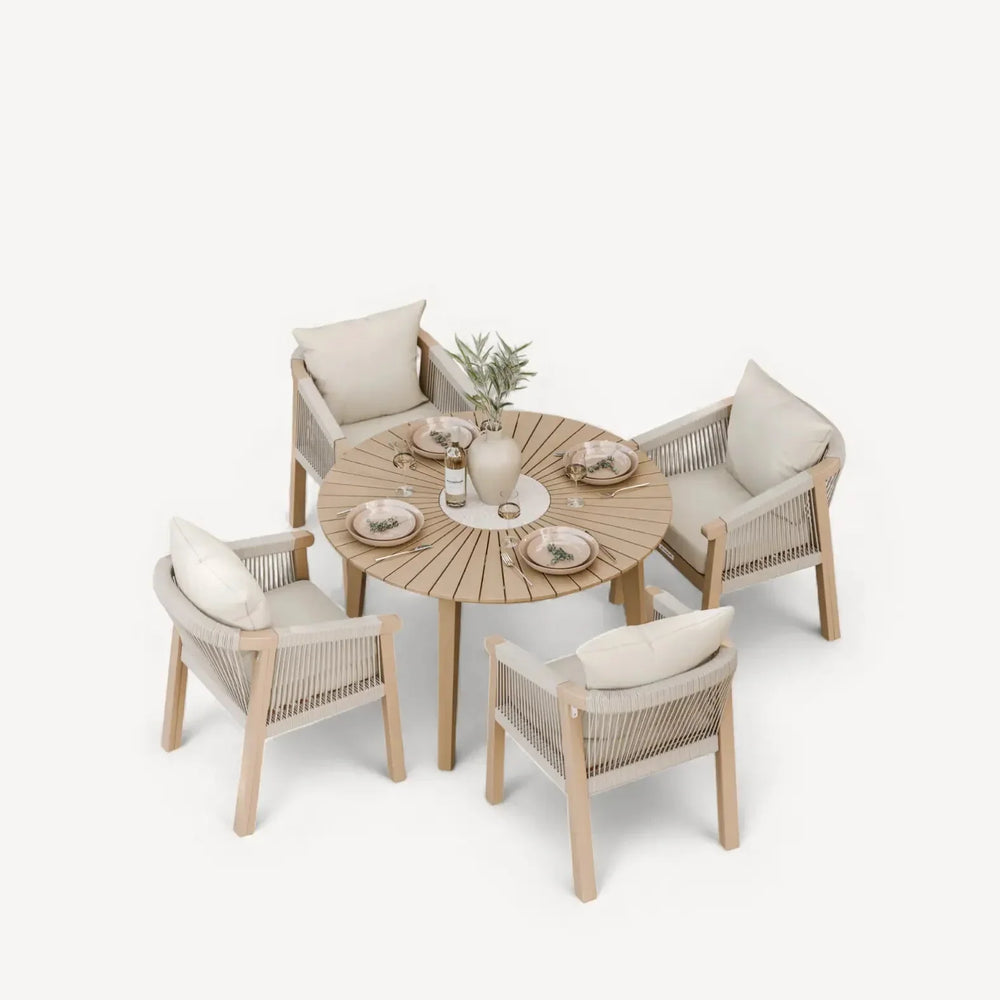 Modern round wooden dining table set with four rope accent chairs and cream cushions