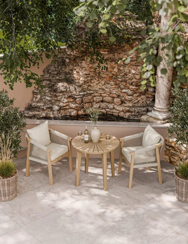 Outdoor garden bistro set with round table and two rope chairs on tiled patio