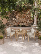 Outdoor garden bistro set with round table and two rope chairs on tiled patio