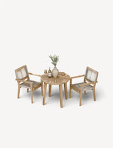 Wooden garden bistro set with round table, two chairs, and neutral decor accents