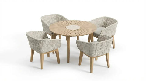 Round wooden dining table with four woven rattan armchairs and light seat cushions