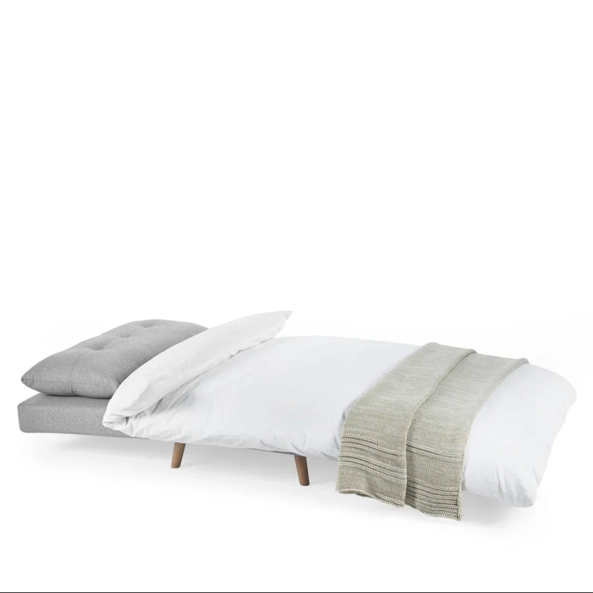 Grey single sofabed with tufted cushion extended as bed, white bedding and wooden legs