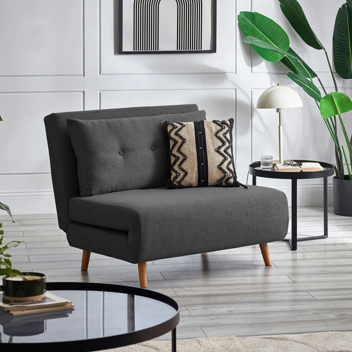 Mid grey single sofabed with wooden legs in modern living room setting