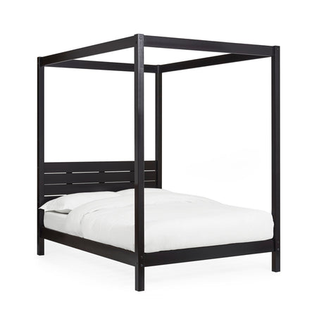 Black wooden canopy bed with white bedding shown at an angle on a white background