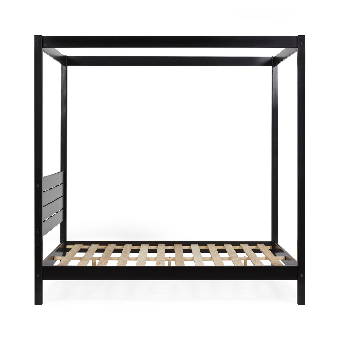 Close-up on black wooden canopy bed post with blurred modern wall art in the background