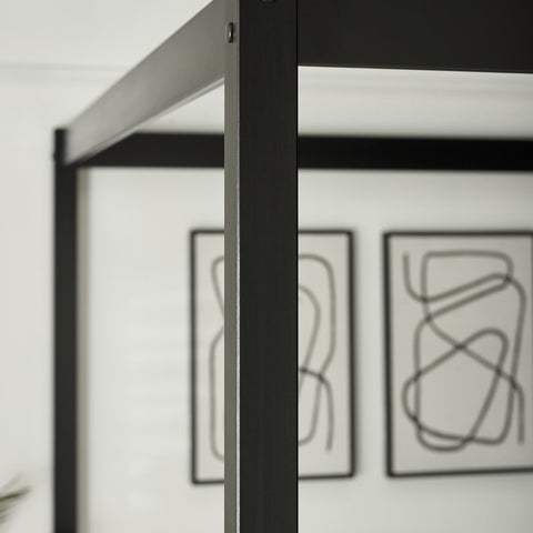 Close-up of black slatted wooden headboard of a canopy bed with smooth finish