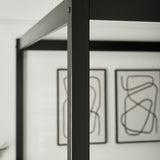 Close-up of black slatted wooden headboard of a canopy bed with smooth finish