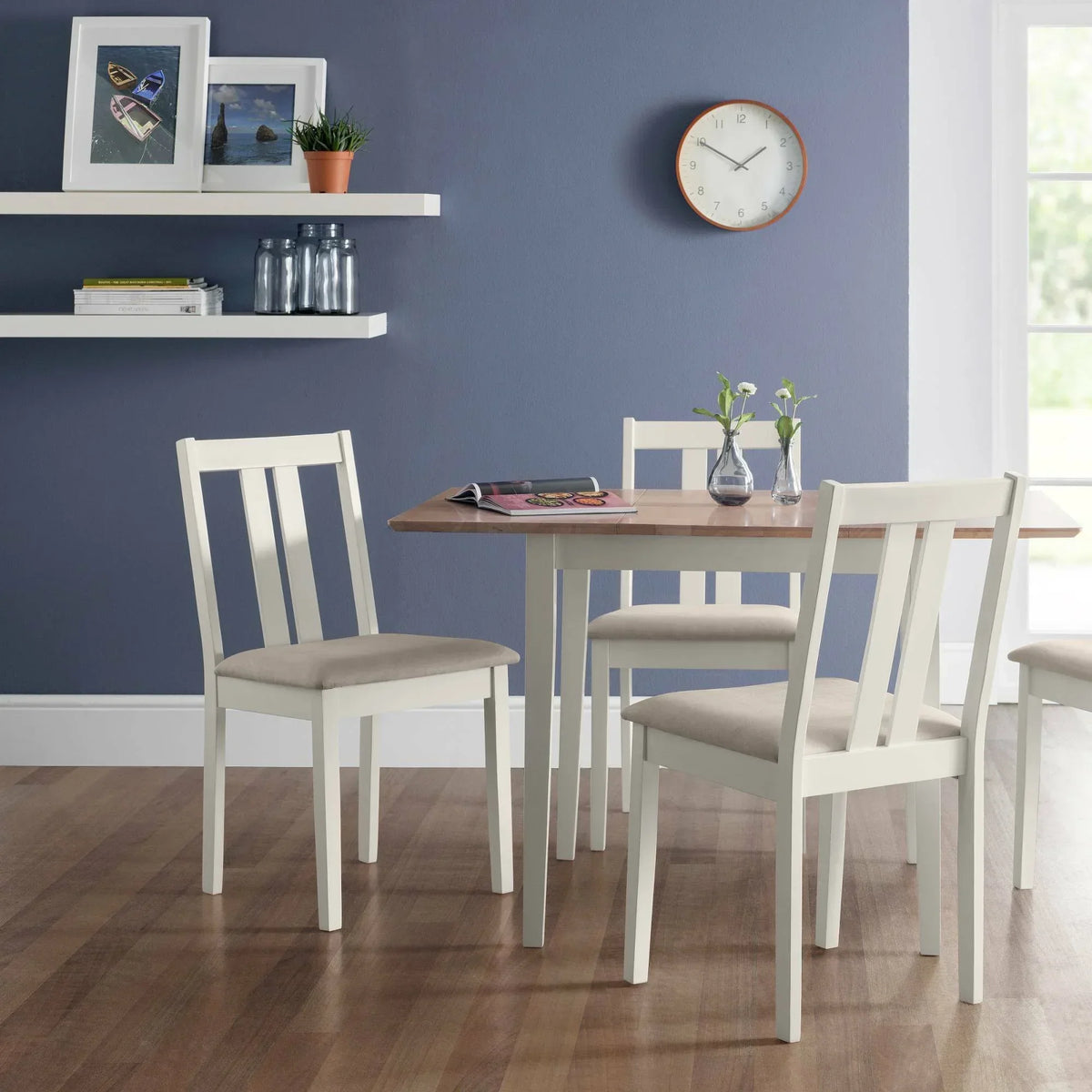Ivory and natural wood dining table with four matching chairs in a modern dining room setting