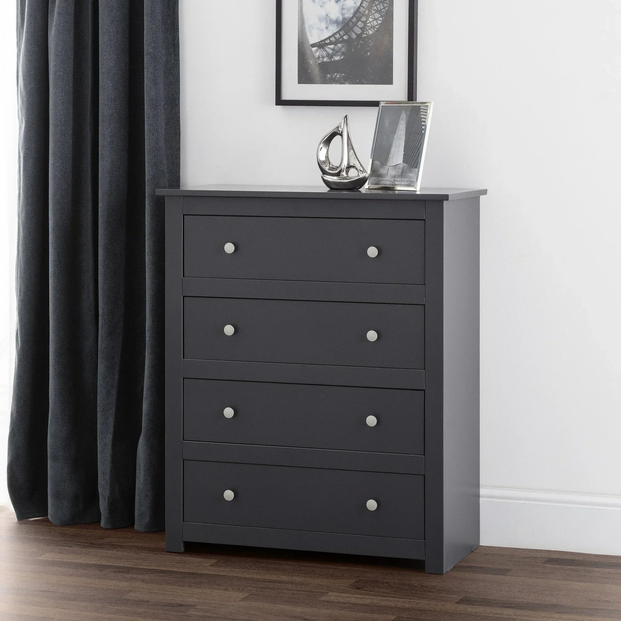 Anthracite 4 drawer chest with silver handles in modern bedroom corner on wooden floor