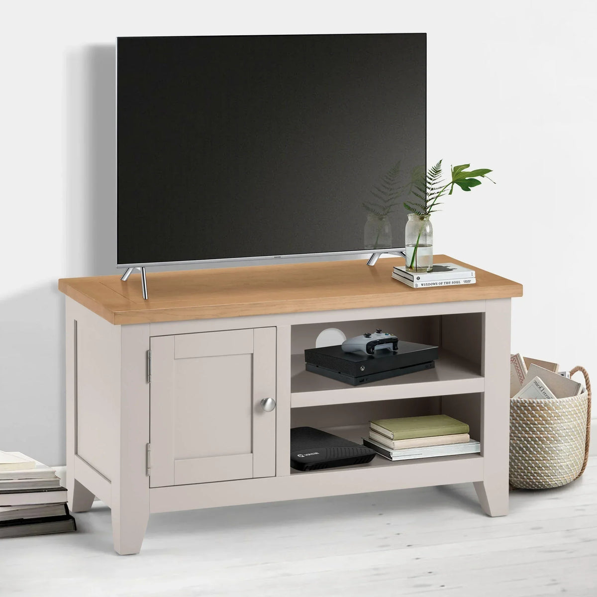 Beige and oak TV unit with shelves, cabinet, and decor in modern living room setting