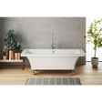 Modern freestanding bathtub in a bathroom with plants and a gray wall.