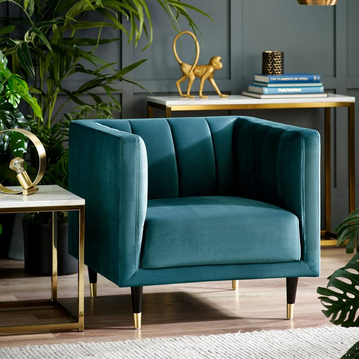 Teal velvet scalloped back chair with gold-tipped legs in modern living room setting