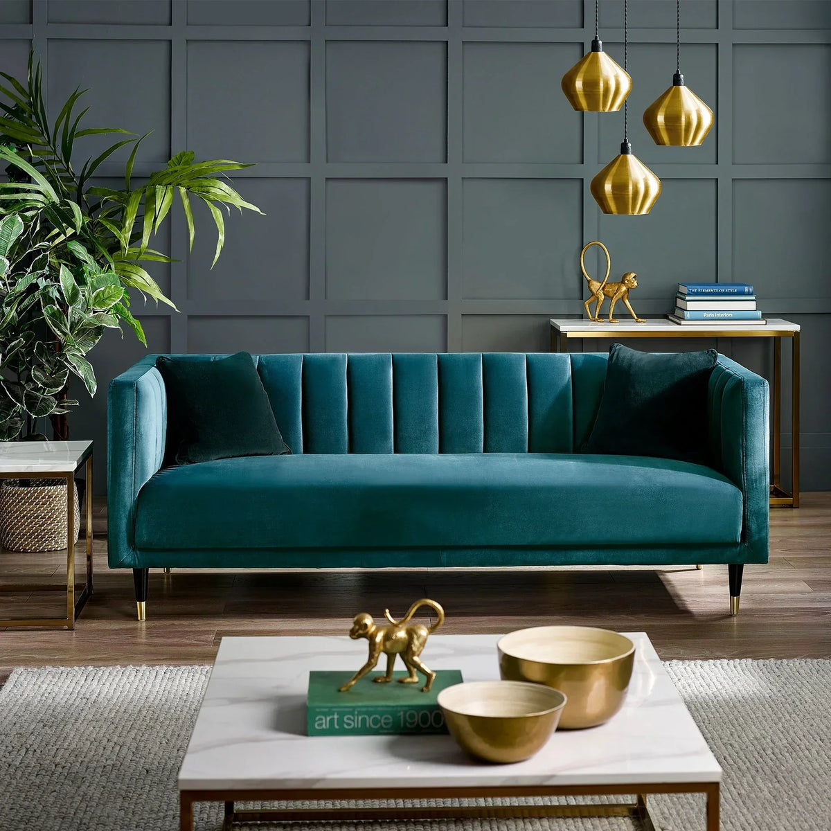 Teal scalloped back 3 seater sofa with gold legs in modern living room setting