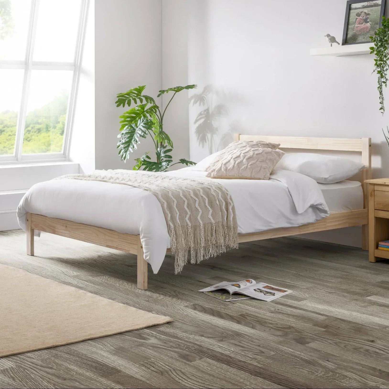 Unfinished pine single bed with white bedding in bright modern bedroom