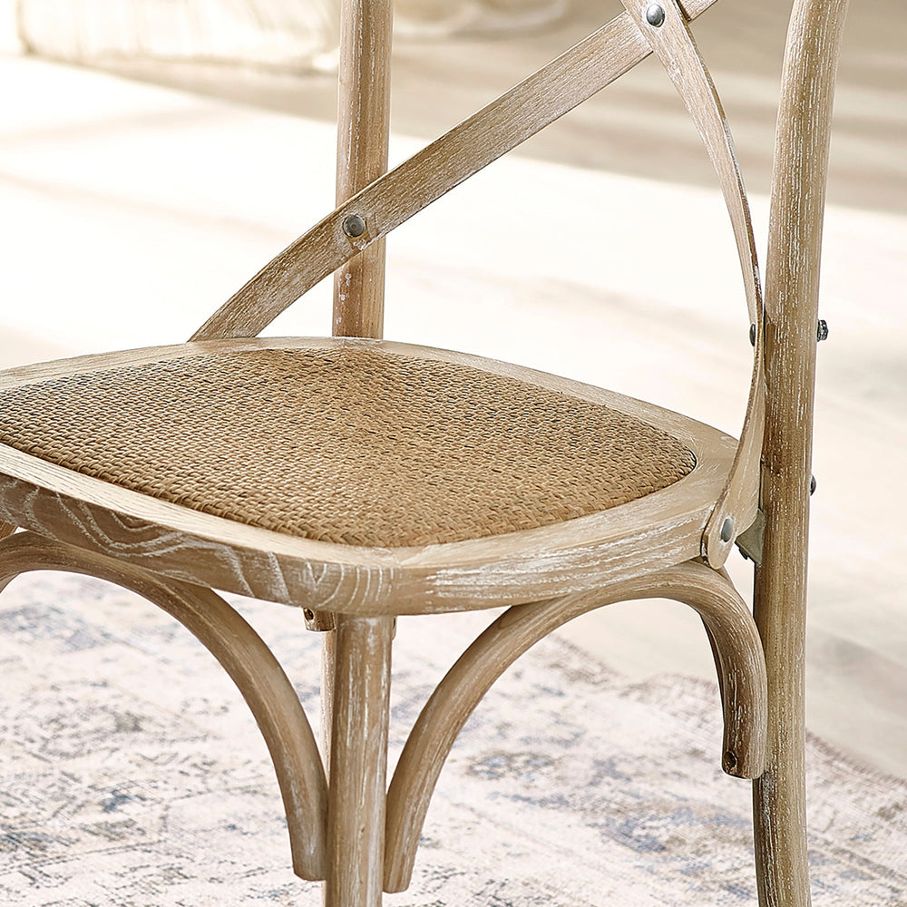 Close-up of light wooden dining chair cane seat with woven texture and curved supports