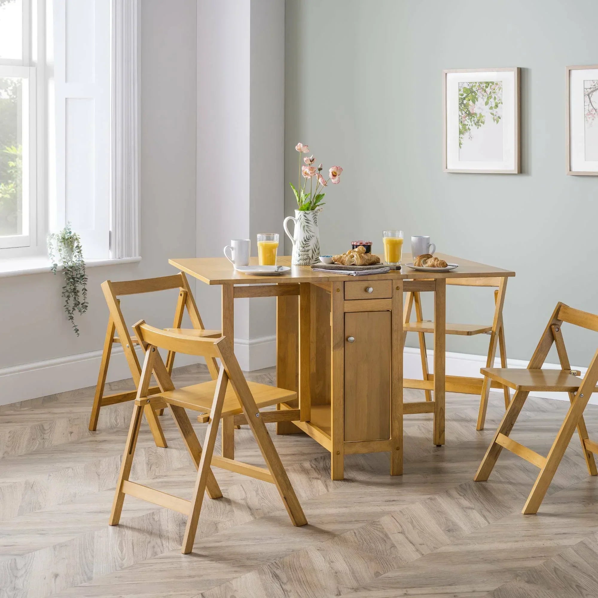 Light oak dining set with foldable chairs and table set for breakfast in bright dining room